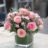 compact pink flower bouquet in a square vase