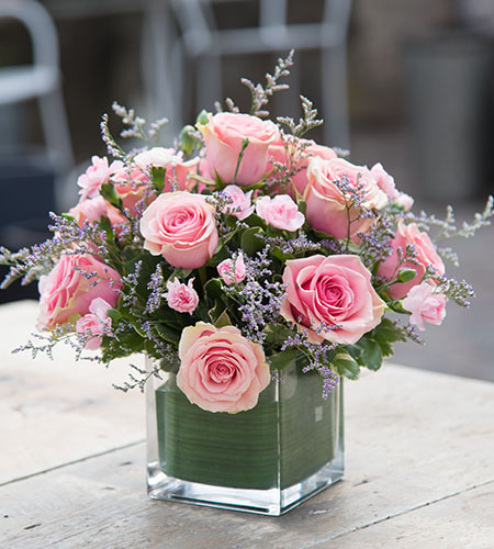 compact pink flower bouquet in a square vase